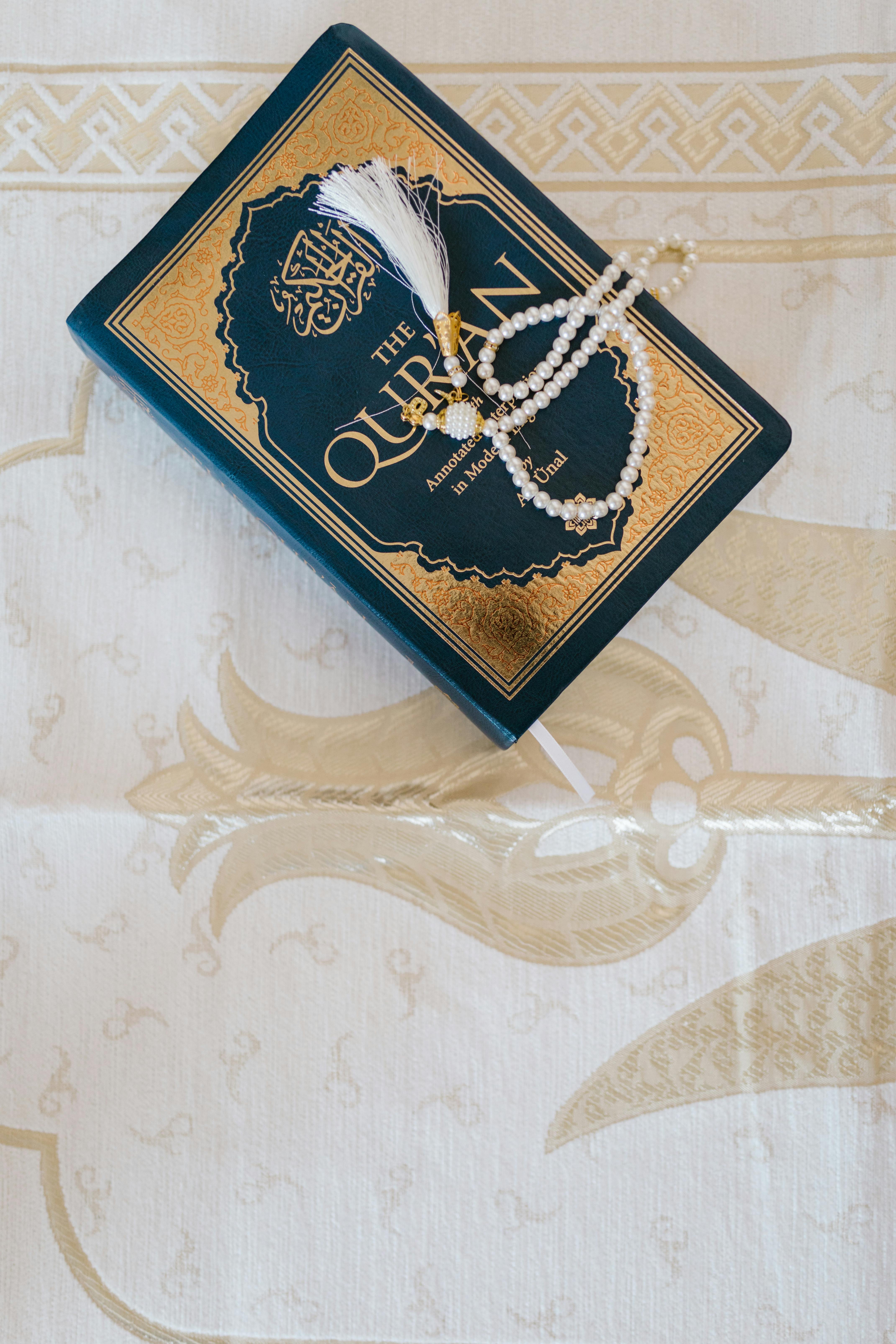 Person reading Quran open on table